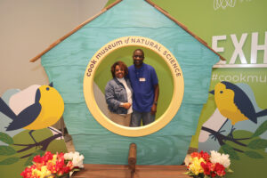 Couple takes photo in nature vignette at Cook Museum.